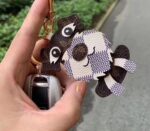 LV bag charm (dog/faceless man)