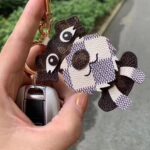 LV bag charm (dog/faceless man)